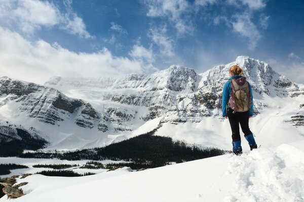 A girl in the winter snow-capped mountains