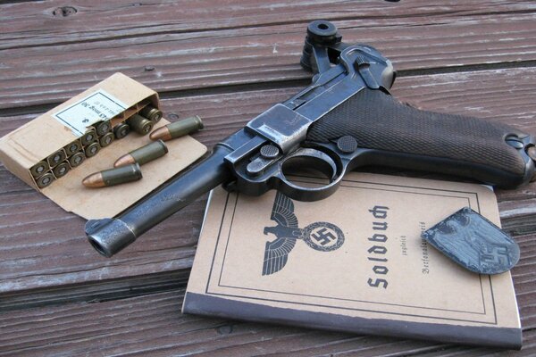 German pistol with cartridges and a book