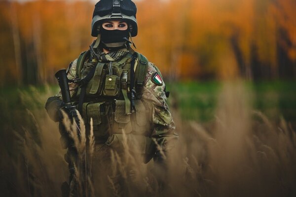 A girl in a military uniform with a gun