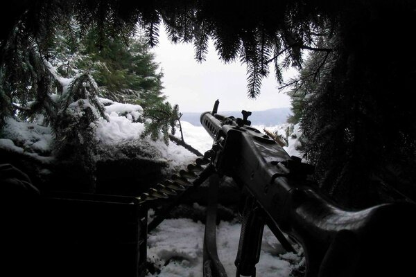 Machine gun in uktytie in the forest in winter