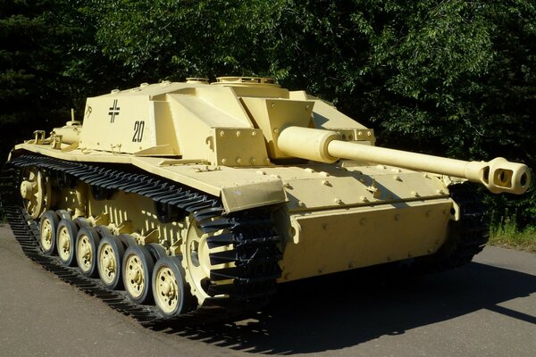 Photo of a military tank on a background of greenery