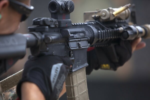 A soldier aiming a rifle with glasses