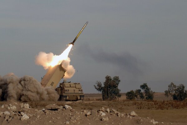 A rocket flying into the gray sky