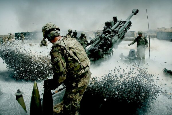 A soldier in uniform on the background of a combat vehicle