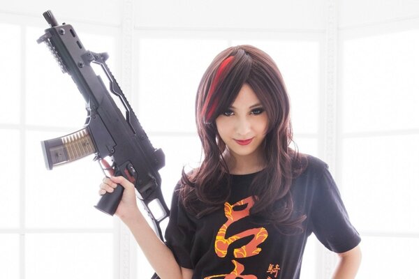 Brunette girl with a gun on a white background