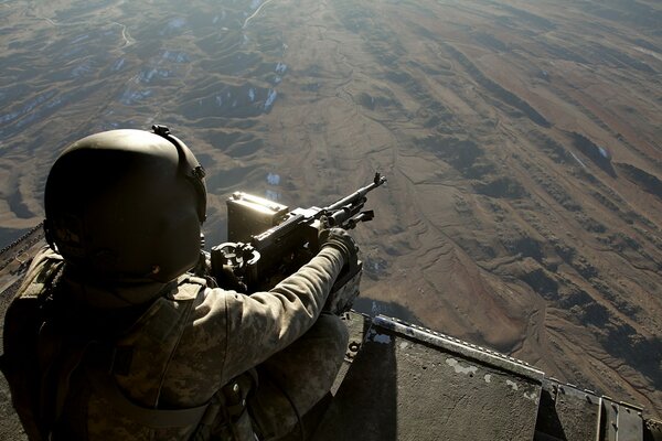 A sniper in a helmet and with a rifle in his hands