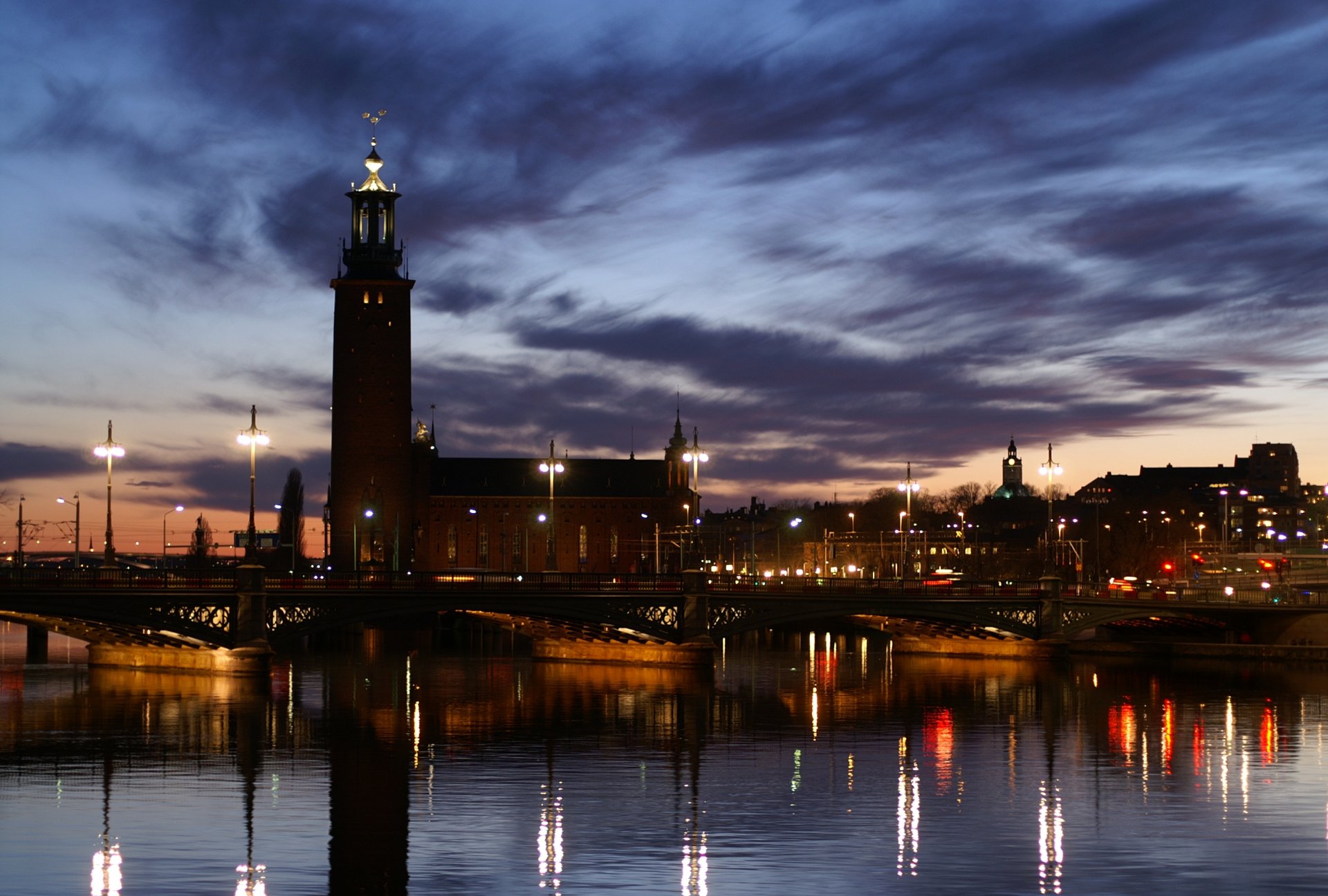 town night sunset sky clouds lamps light lights bridge embankment river reflection