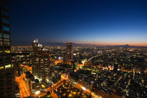 Cielo azul al atardecer sobre las luces ardientes de Tokio