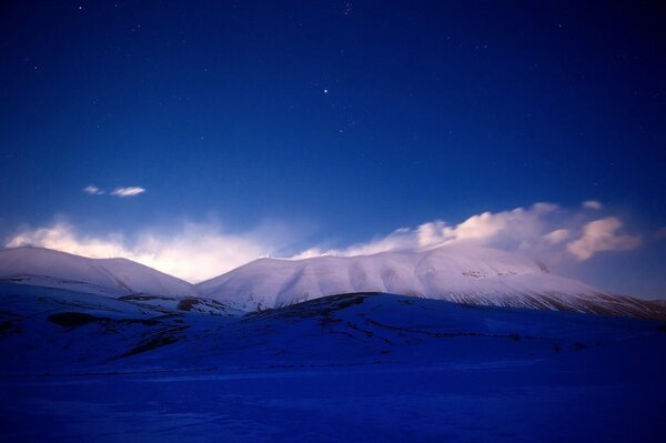 Snowy mountains in the rays of the setting sun