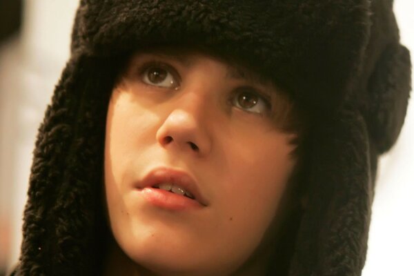 A very young Justin Bieber in a hat