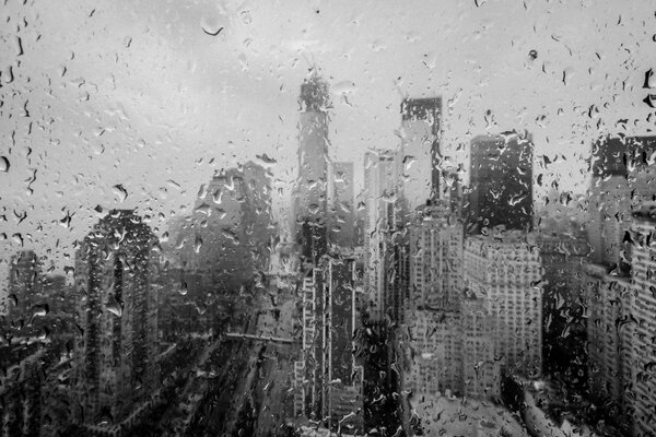 New York skyscrapers through rain-soaked glass