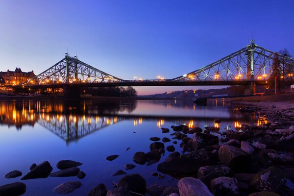 Reflection of the bridge in the water at dusk