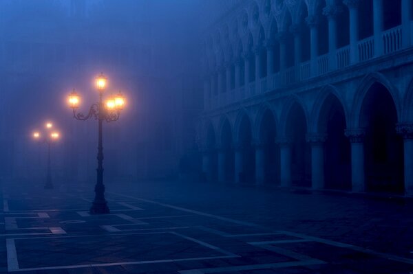 St. Mark s Square in the evening fog and the light of lanterns