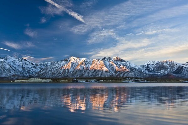 Mountains in the snow on the lake shore