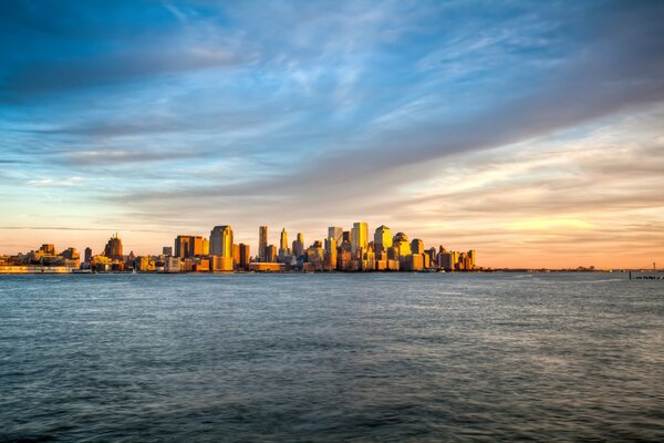 Sunset over the sea on the background of Manhattan in New York