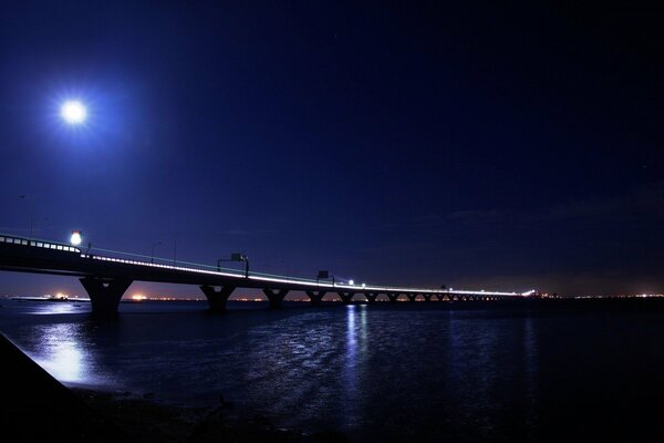 The moon shines over the night bridge