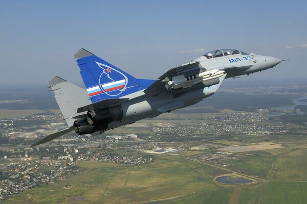 The fighter flies over residential buildings at a low altitude