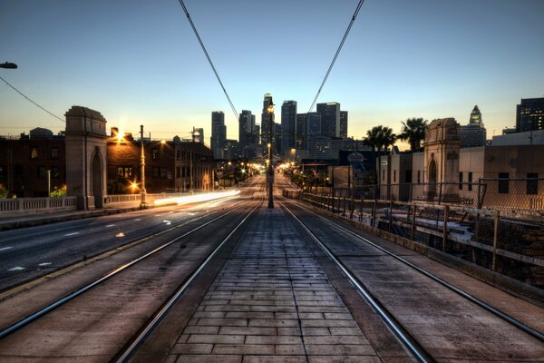 Tram tracks on the background of the setting sun