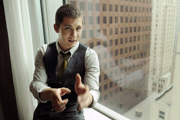 American actor Logan Lerman at the window