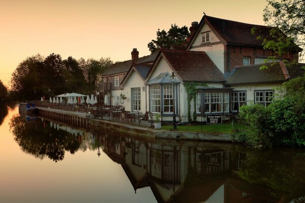 House on the river bank in summer