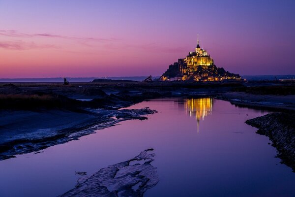 A city in the distance of a purple sky