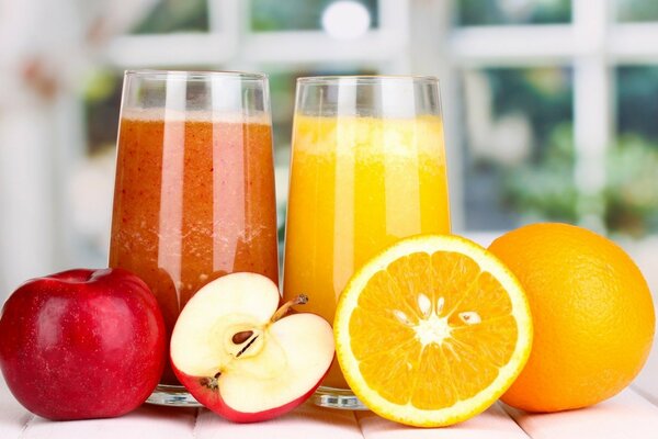 Glasses of Apple and orange juice with fruit