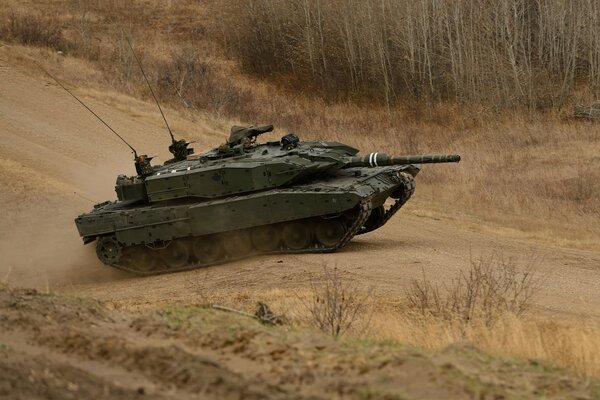 A military tank is driving on the road