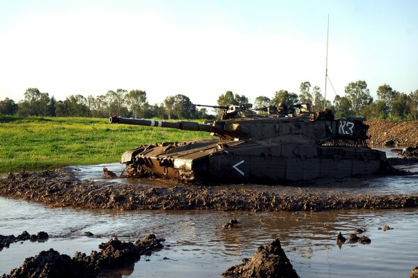 Military tanks are walking through the mud