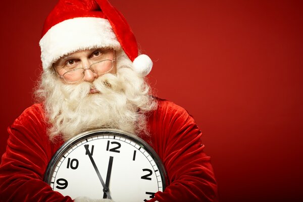 Santa Claus in glasses with a watch