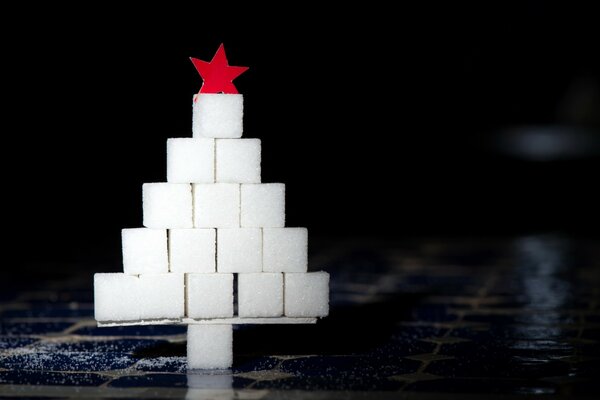 Christmas tree with a red star on a black background