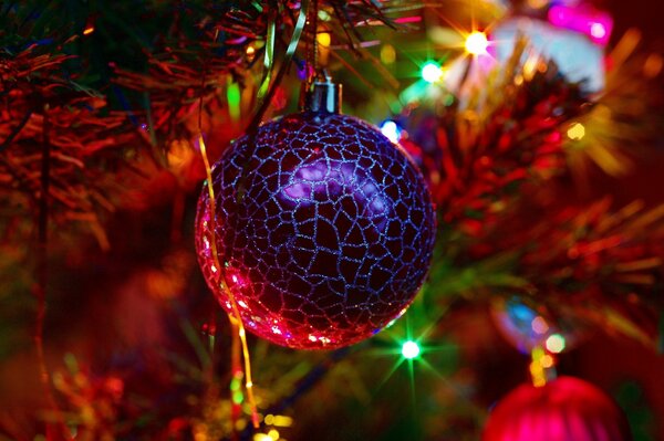 Christmas tree decoration on a branch in twinkling lights