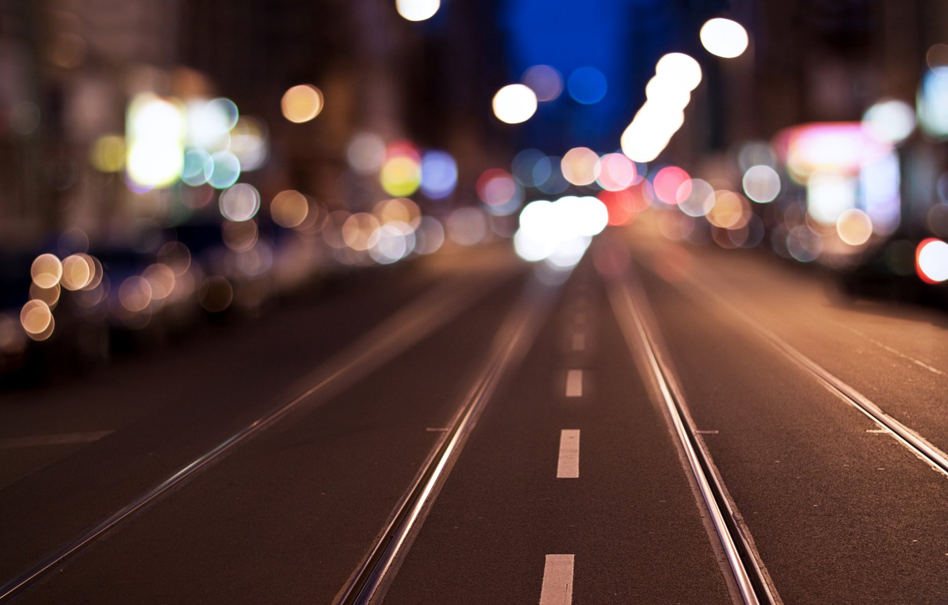 bokeh blur town street construction reflections road dividing line rails the path away the way strip of sky night lights cars