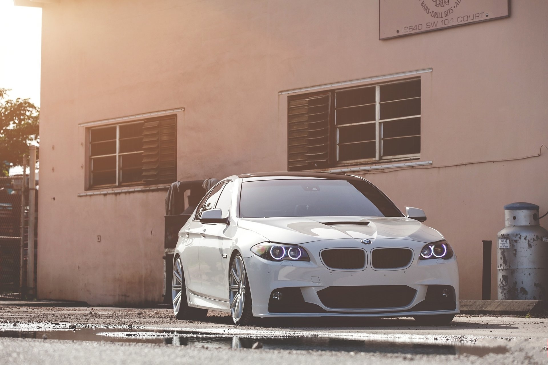 front bmw 550i white bmw f10 white puddle daylight