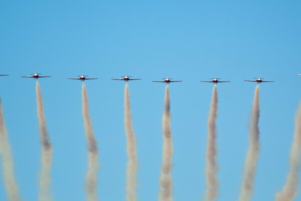 Aviation draws stripes in the blue sky