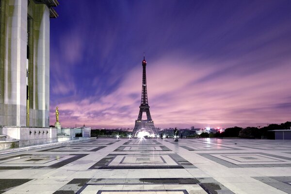 View of the Eiffel Tower from the Louvre against the sunset sky