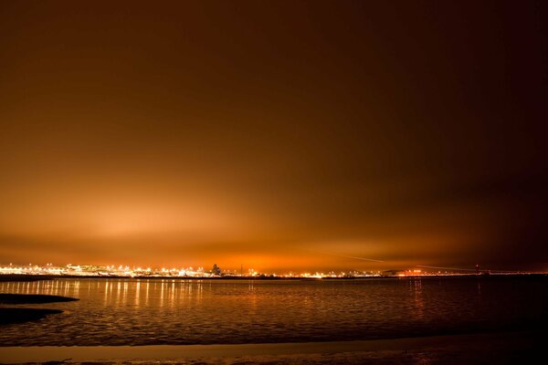 Sunset on the seashore with a view of the city