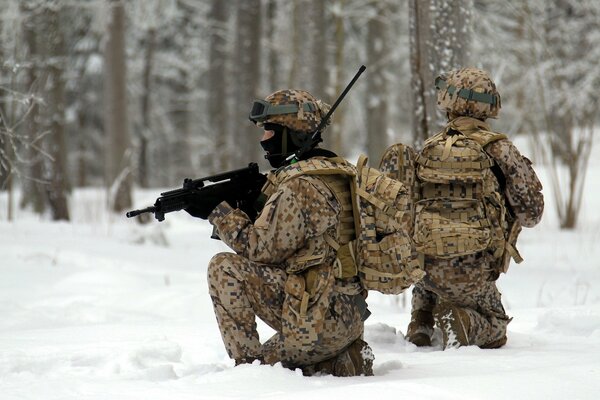 Two soldiers with weapons in the snow