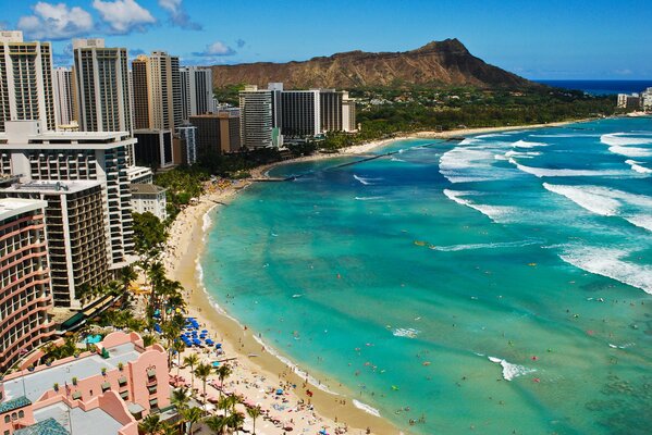 The ocean shore with a beach and multi-storey buildings on the shore