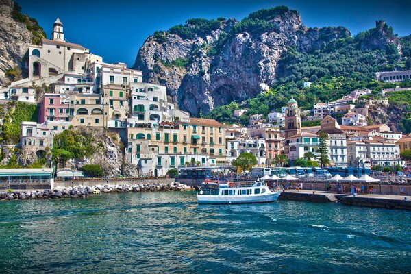 The city of Italy. A boat and a boat at sea. Clean water and unusual houses