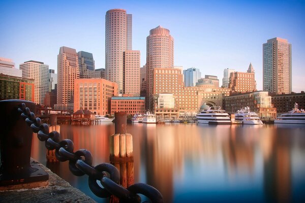 Urban landscape of a big city with high-rise buildings in the reflection of the water surface