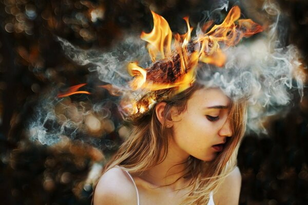 A girl with burning hair on a dark background