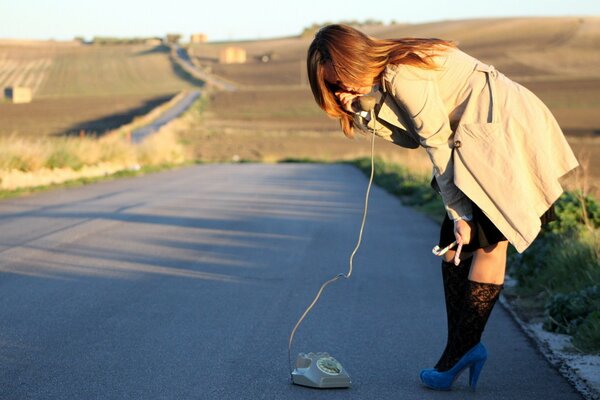 Chica con Teléfono fijo en la carretera