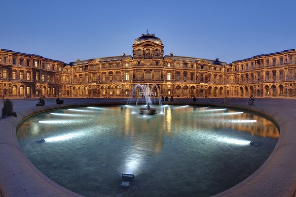 Fountain near the Louvre in the evening