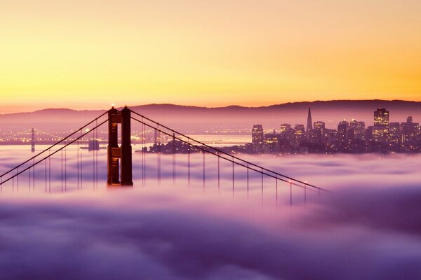 Most Golden Gate w San Francisco przy mglistej pogodzie o zachodzie słońca