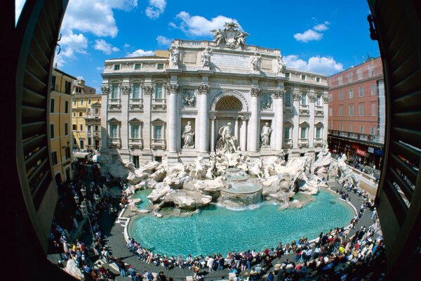 People at the fountain in the square in Italy