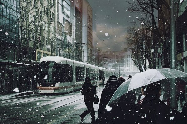 Umbrellas snow people tram