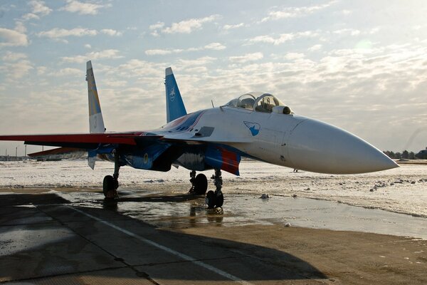 The fighter stands against the background of the round-up sky