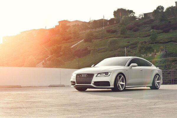 Audi silvery a7 sportback near the hills