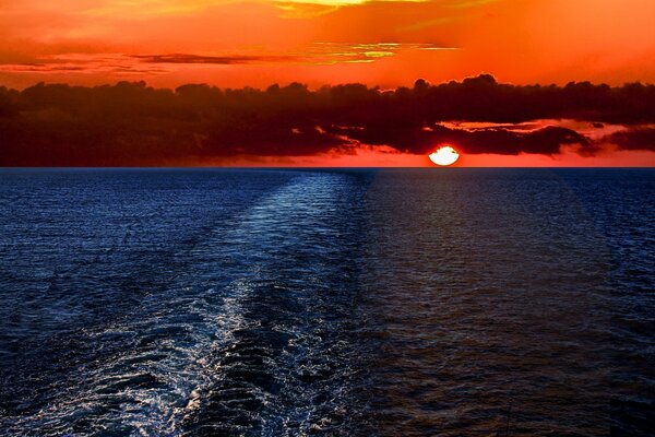 Red sunset on the sea. Clouds over the water