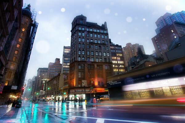 Buildings of the city. A street with wet asphalt